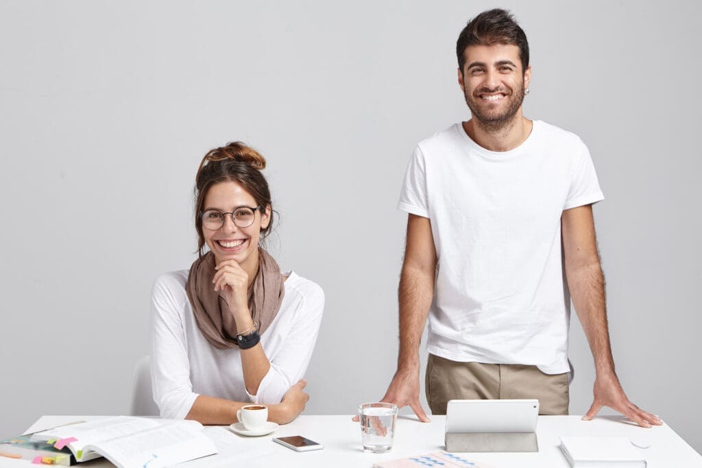 Happy business owners, a man and a woman, after their books were cleaned up by Two Rivers Bookkeeping