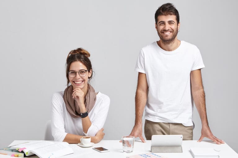 Happy business owners, a man and a woman, after their books were cleaned up by Two Rivers Bookkeeping